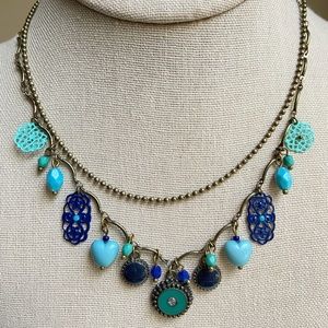 OHQ double strand necklace in antiqued brasstone with aqua and navy blue dangles